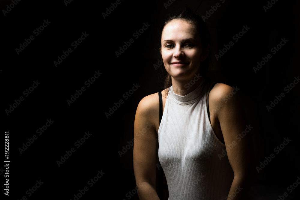 Cute brunette woman with long hair posing in low key Cute brunette woman with long hair posing in low key