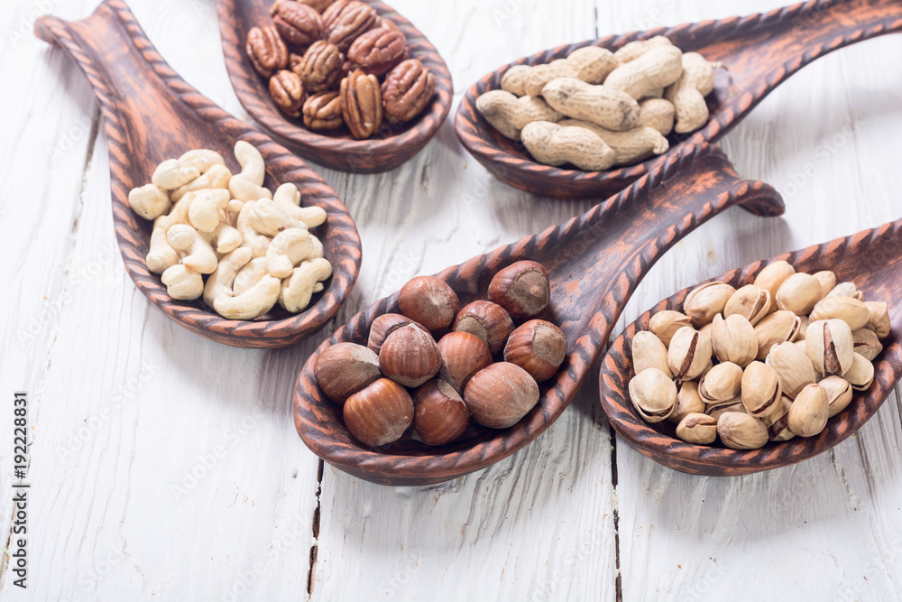 Mix of nuts in wooden spoon Mix of nuts in wooden spoon