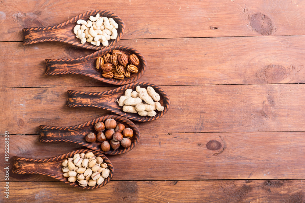 Mix of nuts in wooden spoon Mix of nuts in wooden spoon