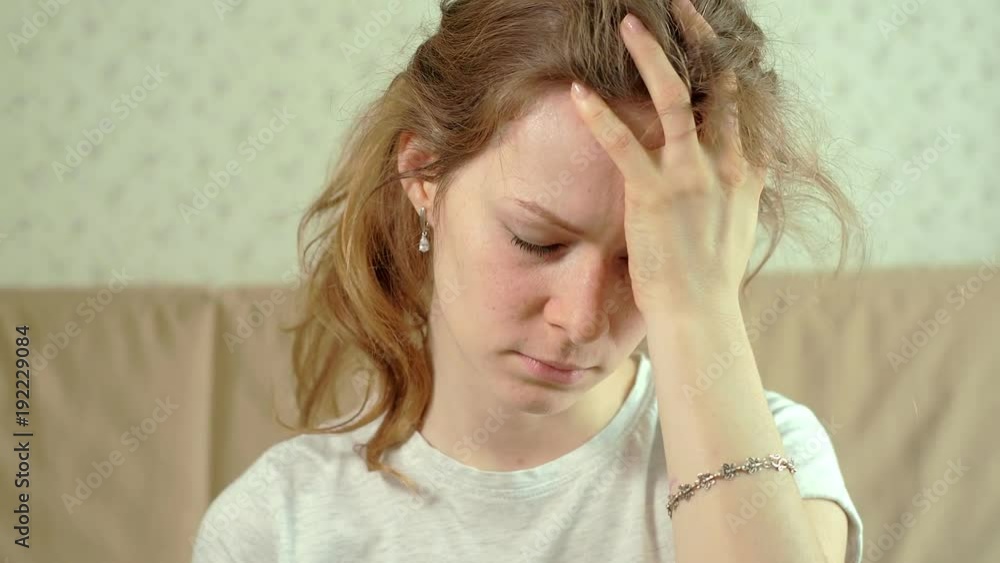 woman with headache holding her hand to the head woman with headache holding her hand to the head