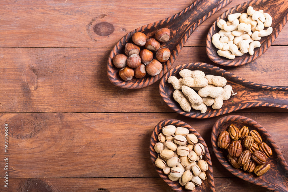 Mix of nuts in wooden spoon Mix of nuts in wooden spoon