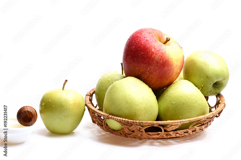 Apples in wicker bowl isolated on white background, close up Apples in wicker bowl isolated on white background, close up