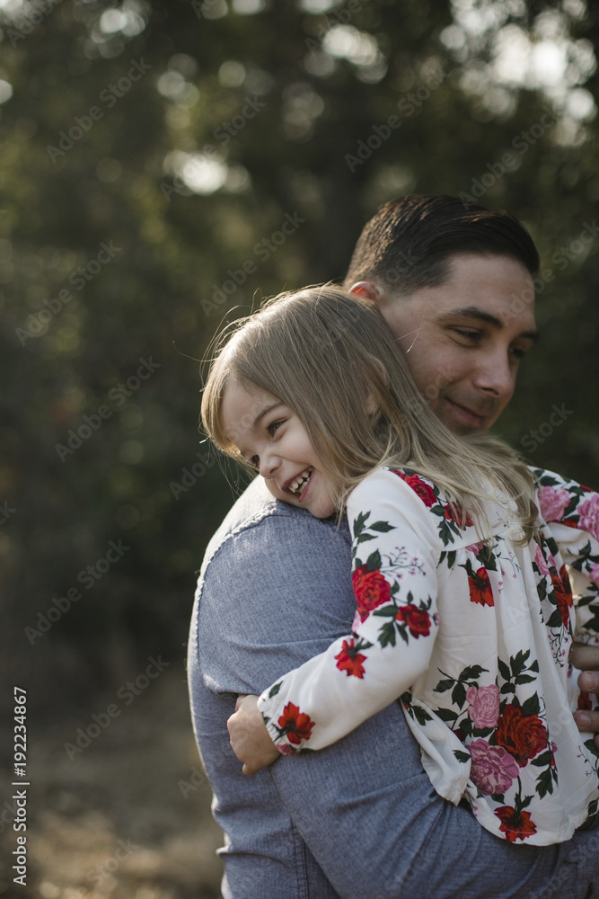 Father carrying smiling daughter on field Father carrying smiling daughter on field