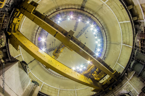 Bottom view of industrial polar rotary crane of bridge type. Construction of dome  photo