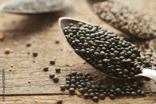 close up of puy lentils on old silver spoon photo