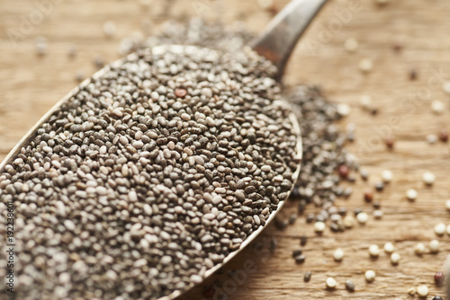 close up of vintage spoons with chia seeds lieing on wooden old table