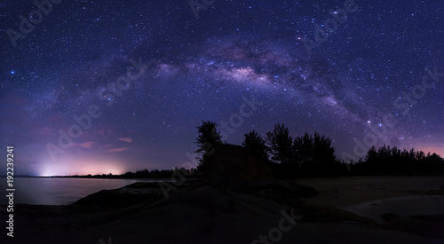 Stitched Panorama starry night sky with milky way. image contain soft focus, blur and noise due to long expose and high iso. © udoikel09
