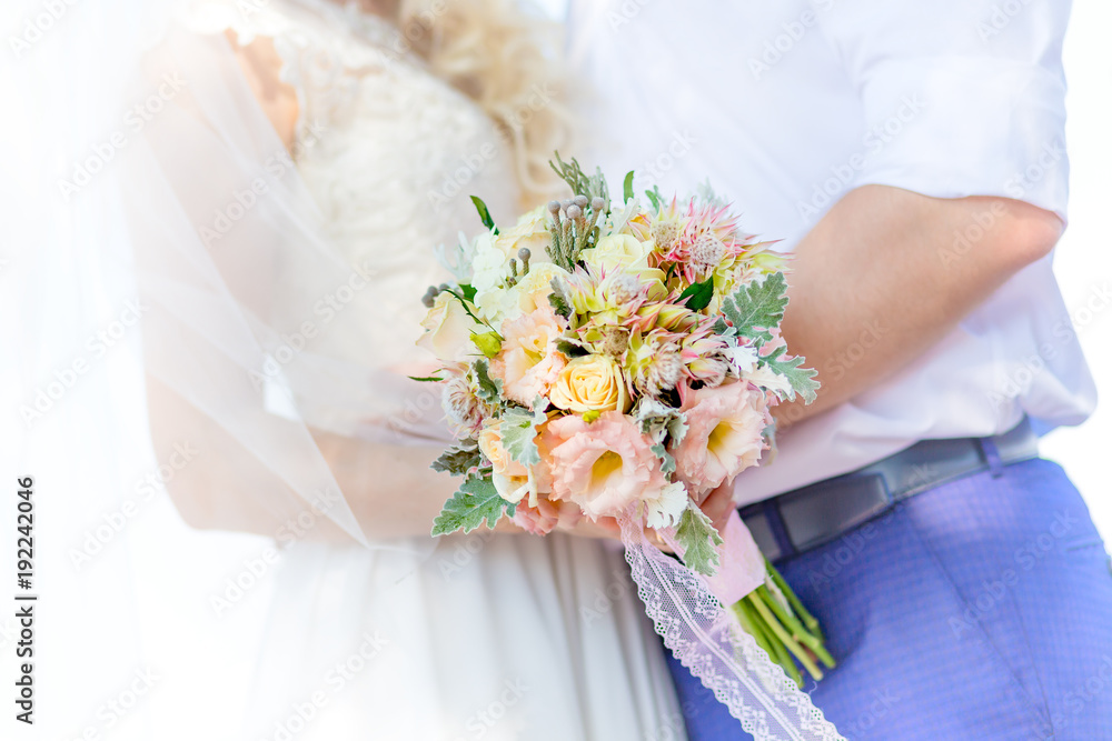 Bridal bouquet. A bouquet of flowers is kept in the hand by a bride at a wedding. Emotion of love is the tenderness Bridal bouquet. A bouquet of flowers is kept in the hand by a bride at a wedding. Emotion of love is the tenderness