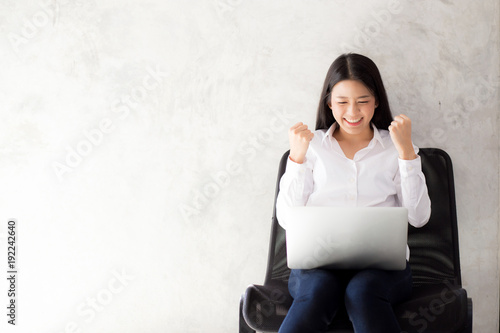 Beautiful asian young woman excited and glad of success with laptop, girl working coffee shop on cement background, career freelance business concept.