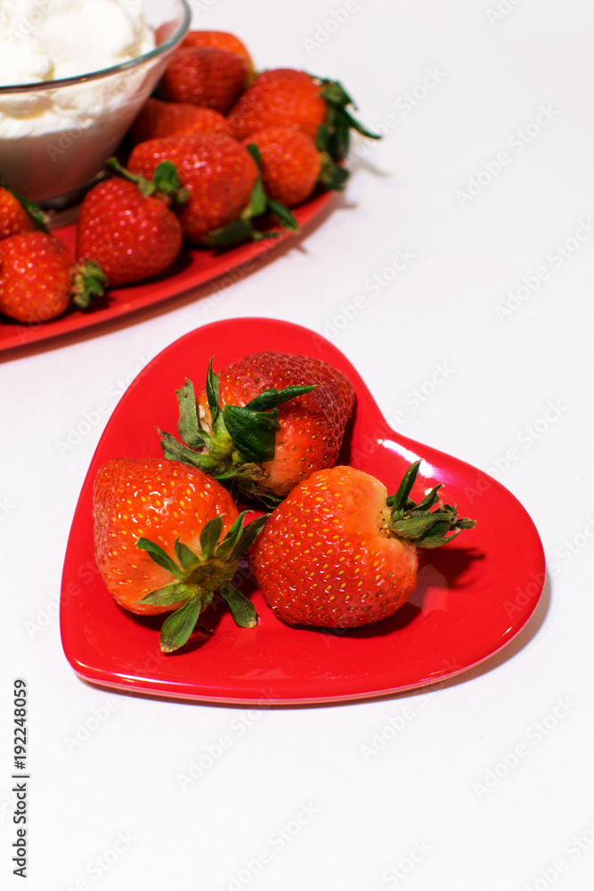Small heart plate in front with strawberries bigger one behind. Small heart plate in front with strawberries bigger one behind.
