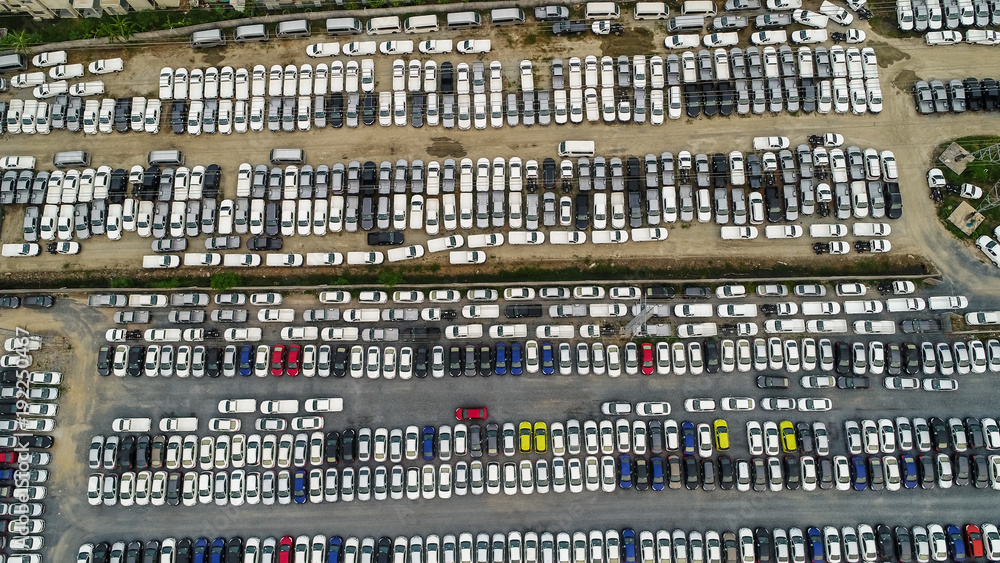 Aerial Top view of new cars lined up at Industrial factory Port, Logistics import - export and transportation concept