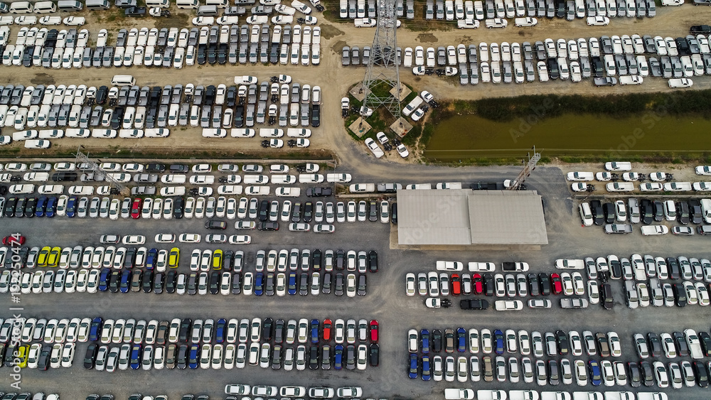 Aerial Top view of new cars lined up at Industrial factory Port, Logistics import - export and transportation concept Aerial Top view of new cars lined up at Industrial factory Port, Logistics import - export and transportation concept