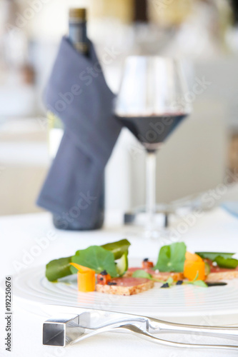 Exquisite salmon dish served with red wine  creative restaurant meal concept  haute couture food