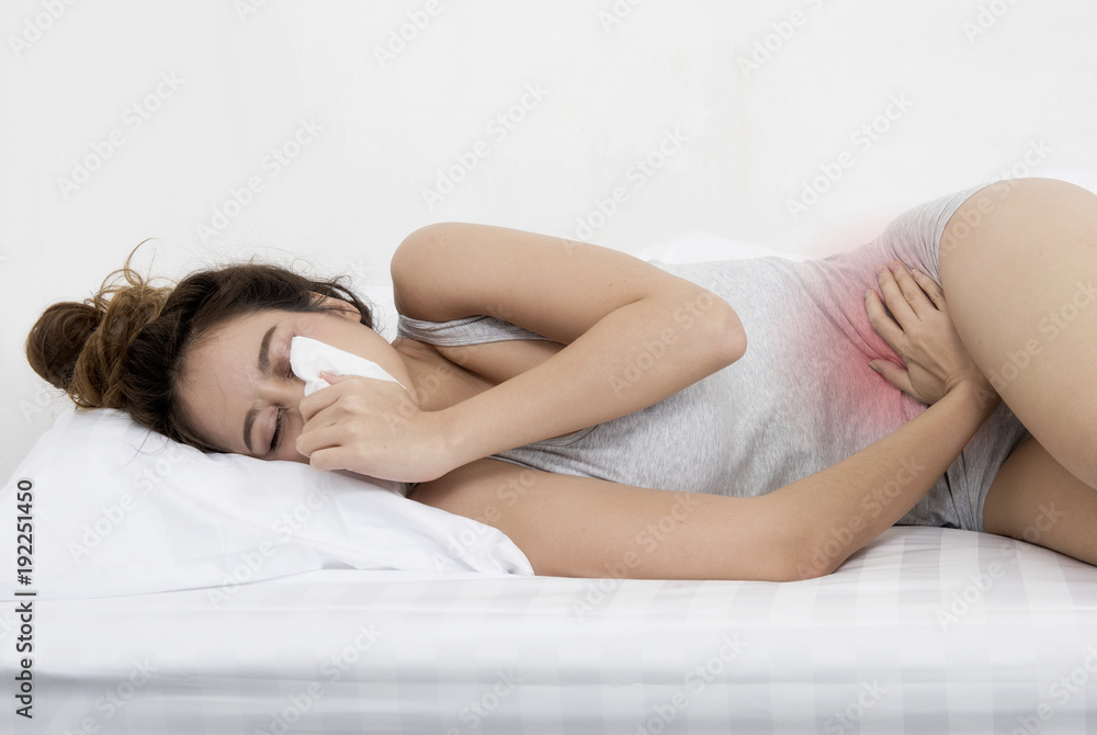 Attractive woman with have a runny nose at home on the bed Attractive woman with have a runny nose at home on the bed