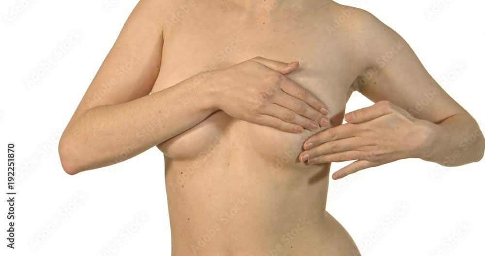 Close-up of young shirtless woman examining her breasts. Close-up of young shirtless woman examining her breasts.