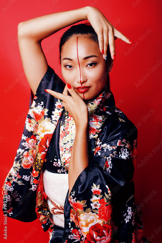 pretty geisha on red background in kimono, oriental people concept close up Stock Photo | Adobe Stock