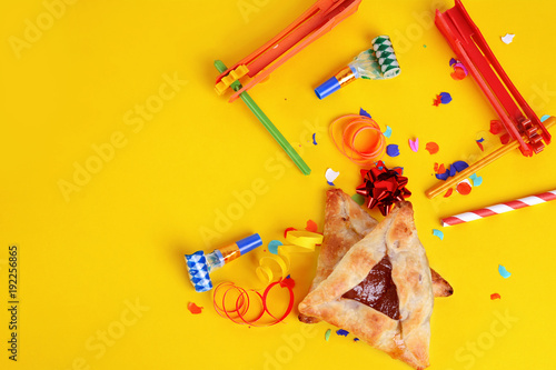 Purim background with party costume and hamantaschen cookies. photo