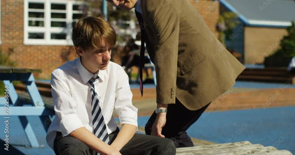 4k, A concerned teacher talking to a young boy teased at school. Slow motion 4k, A concerned teacher talking to a young boy teased at school. Slow motion