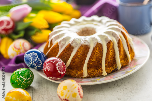 Easter Cake. Traditional ring marble cake withe easter decotation. Easter eggs and spring tulips. photo