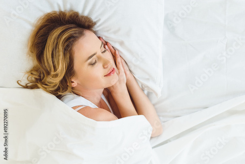 top view of beautiful woman sleeping in bed at home
