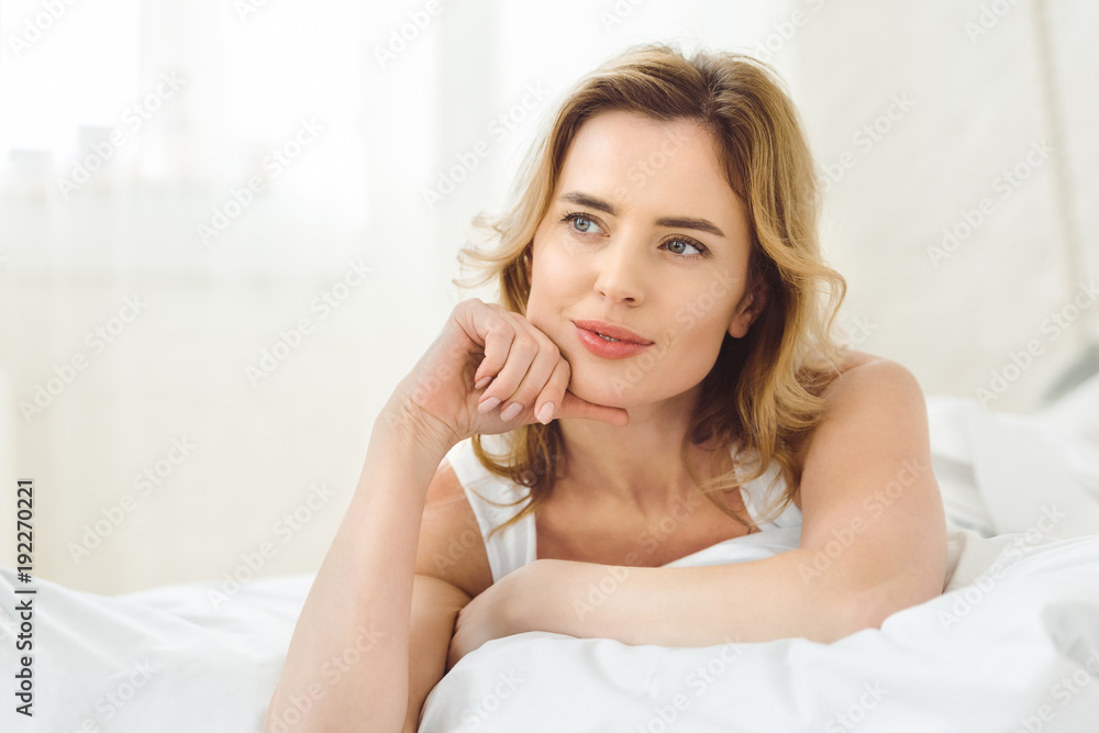thoughtful attractive woman lying in bed at home thoughtful attractive woman lying in bed at home