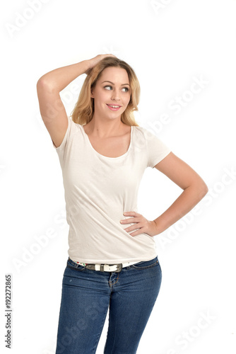 3/4 portrait of blonde girl wearing white shirt, posing with hands touching body. isolated on white background.