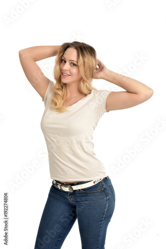 3/4 portrait of blonde girl wearing white shirt,  posing with hands touching body. isolated on white background. © faestock