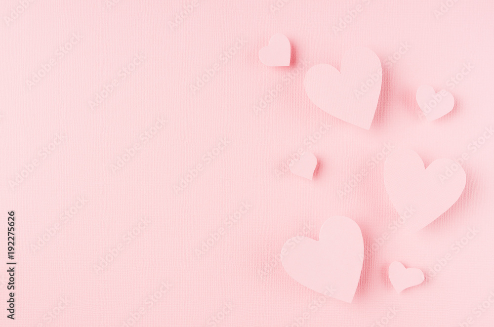 Valentines day background with hearts flying on pink paper, copy space.
