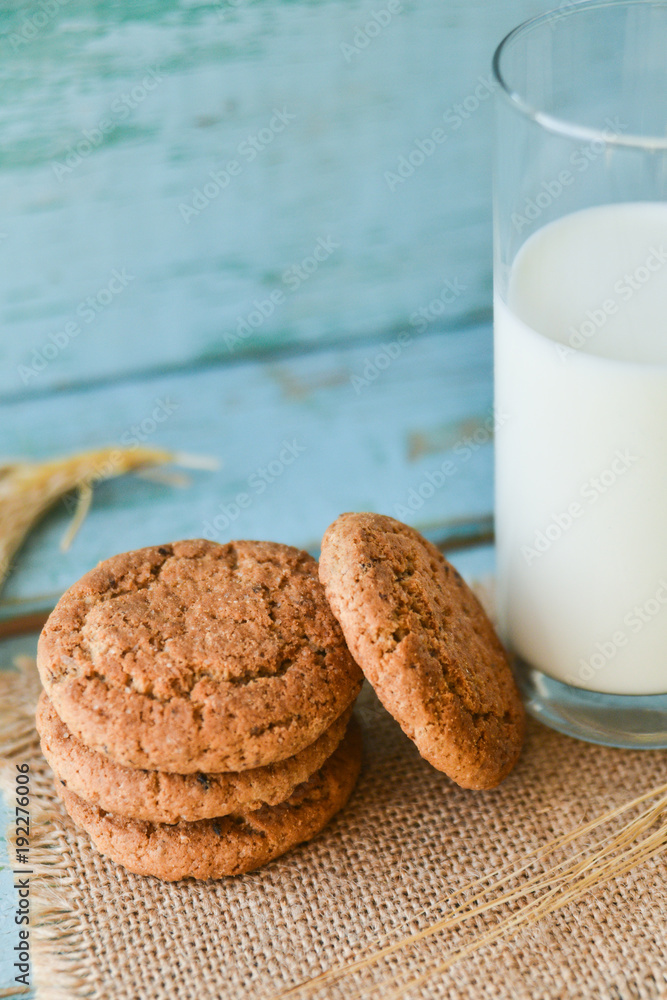 fresh oatmeal cookies with milk on wooden background fresh oatmeal cookies with milk on wooden background