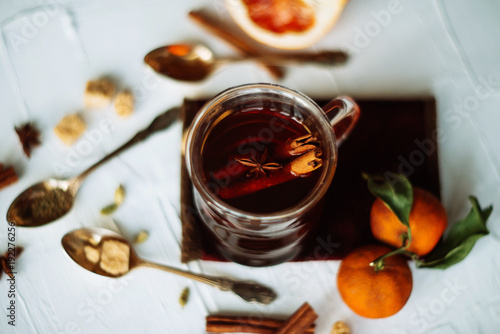 Cup of herbal tea on dark aged rustic background, top view, place for text, border