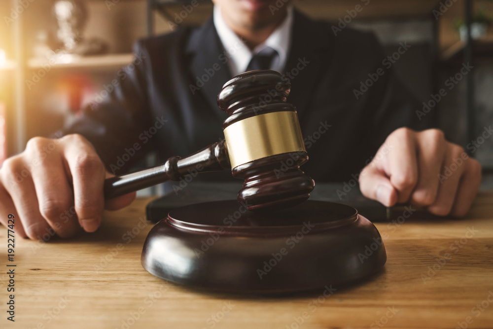 justice and law concept.Male judge in a courtroom with the gavel,working with,digital tablet computer docking keyboard,eyeglasses,on wood table in morning light
justice and law concept.Male judge in a courtroom with the gavel,working with,digital tablet computer docking keyboard,eyeglasses,on wood table in morning light