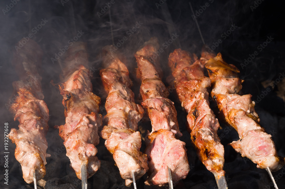 Shish kebab on skewers of marinated meat on a charcoal grill 