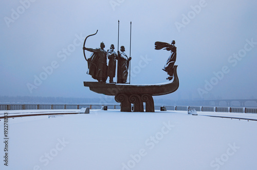 Beautiful Monument to Founders of Kyiv: Kiy, Schek, Khoryv and their sister Lybid. Dnieper (Dnipro) River at the background.  Frosty morning with snowing. Winter landscape photo. Kyiv, Ukraine photo