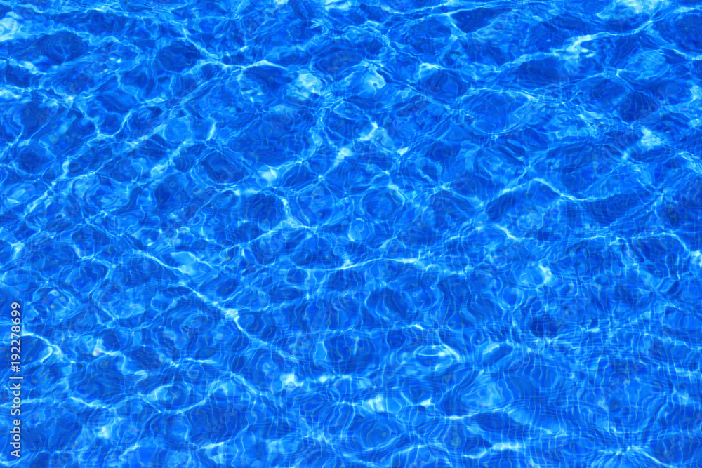 Blue pool water with small ripples and waves in the sun