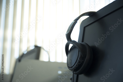 headphone on top desktop computer © Savelight Studio