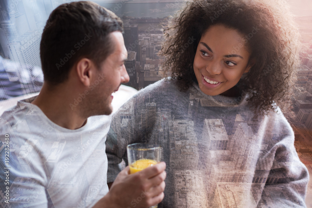 Perfect couple. Nice delighted positive woman looking at her boyfriend and smiling while spending time together Perfect couple. Nice delighted positive woman looking at her boyfriend and smiling while spending time together