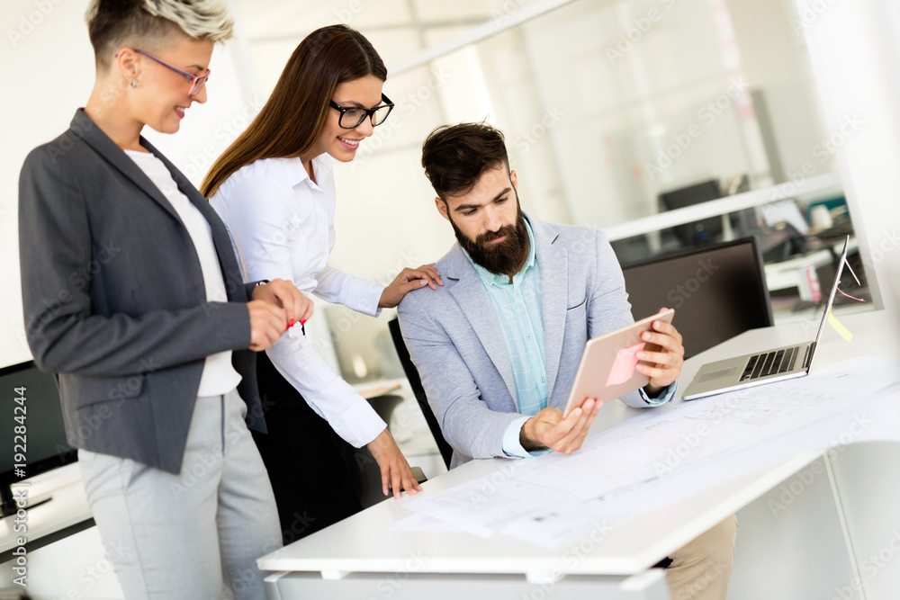 Picture of young architects discussing in office Picture of young architects discussing in office