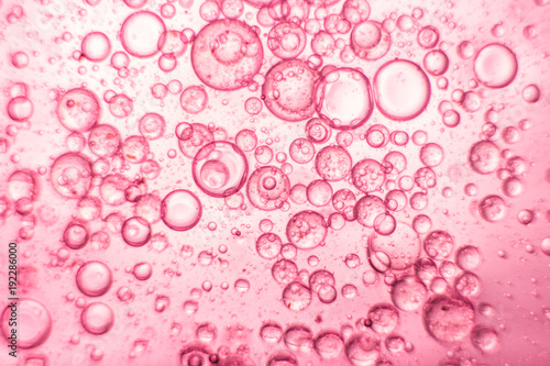 Pink oil bubbles on water surface