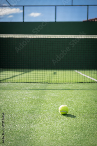 Paddle tennis court and net with a ball
