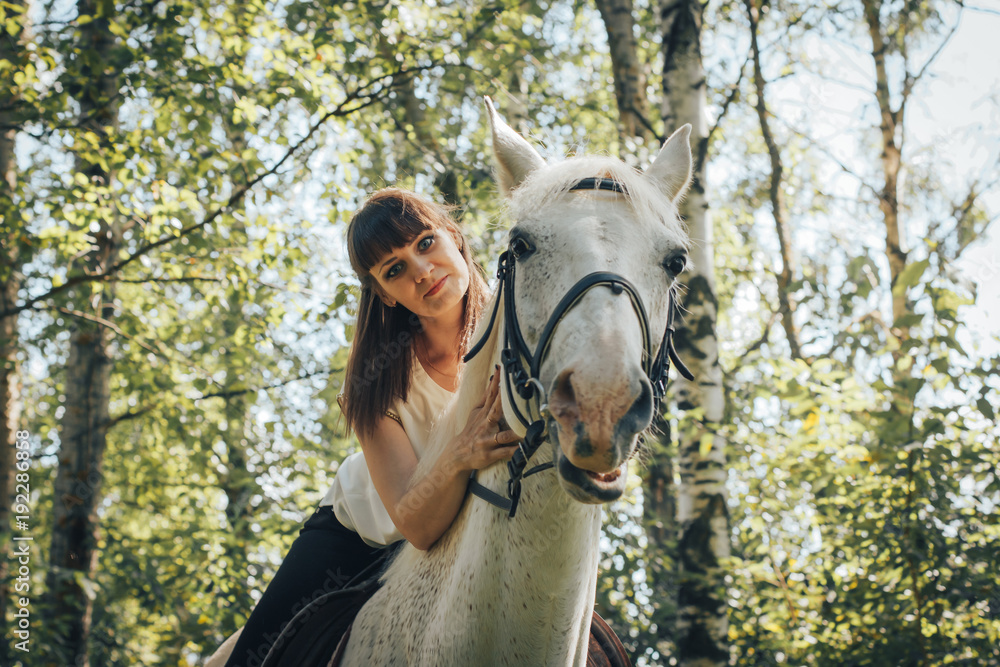 Obraz premium Girl and horse in the woods