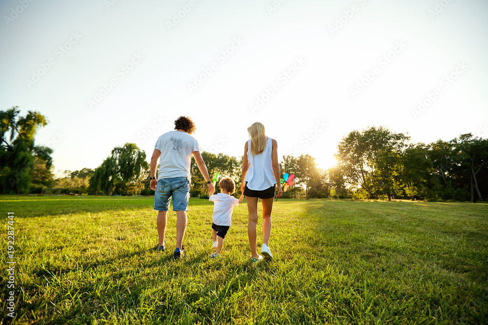 Happy family playing in the park. Mother, father and son play together in nature in the summer, in the spring. Happy family playing in the park. Mother, father and son play together in nature in the summer, in the spring.