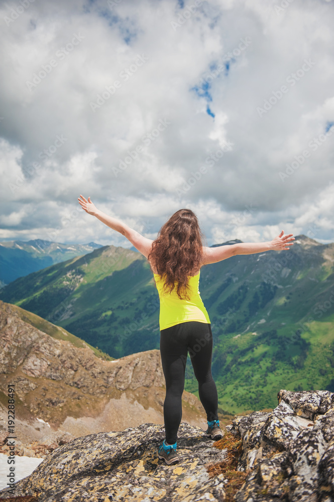 Woman hiker standing on the top of mountain Woman hiker standing on the top of mountain