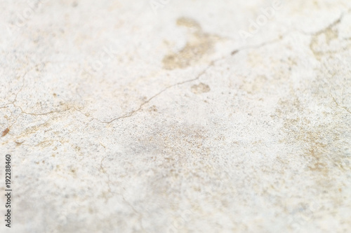 Surface cracked cement-sand mortar leveling screed. Bright blurred abstract background with limited depth of field.