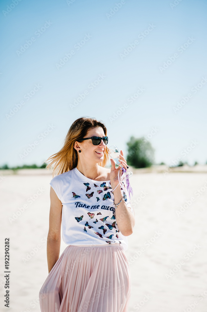 Beautiful stylish sexy young girl with a glass of wine, champagne in sand, beach in the nature. Style boho. Party. Maiden evening Hen-parties. Bachelorette. In glasses. Close up. Beautiful stylish sexy young girl with a glass of wine, champagne in sand, beach in the nature. Style boho. Party. Maiden evening Hen-parties. Bachelorette. In glasses. Close up.