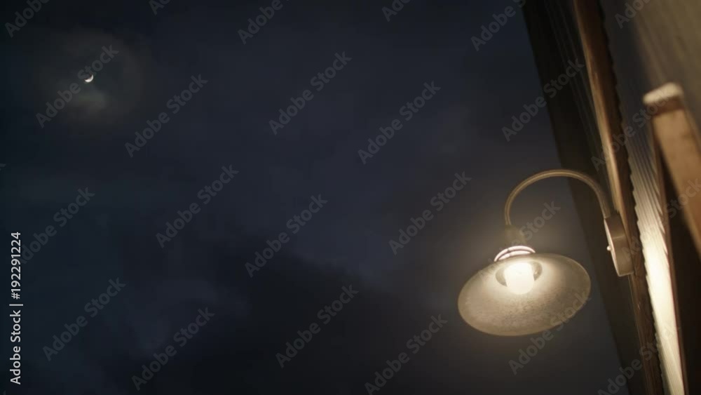 Shot of a street lamp and the moon at night. Shot of a street lamp and the moon at night.