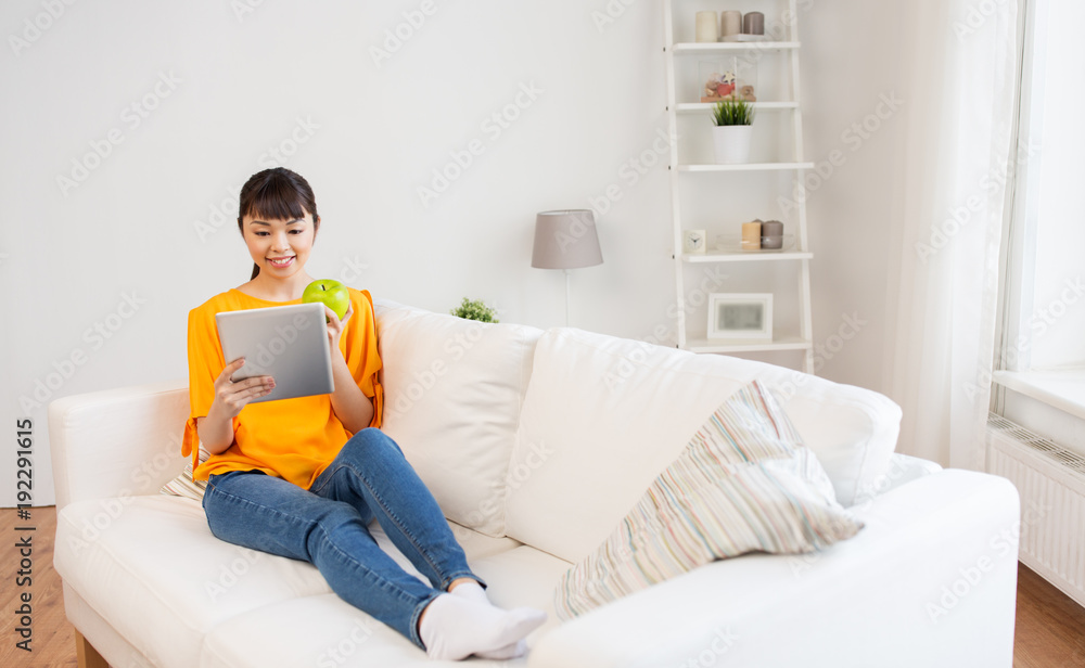 happy asian woman with tablet pc and apple at home happy asian woman with tablet pc and apple at home