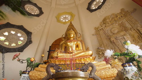 Statue of the Buddha god, Sacrifice oblation, traditional offerings for Gods in the Buddhist temple Brahma Vihara Indonesia. Bali Architecture, Ancient design. Travel concept. photo