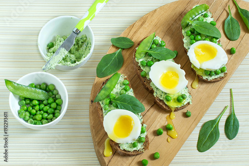 Toast to breakfast with cottage cheese and herbs  green peas  soft egg and spinach