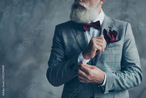 Cropped close up photo of chic virile luxurious trendy wealthy rich sharp well-dressed with burgundy accessories checkered jacket intelligent hipster grandpa fixing cuffs isolated on grey background photo