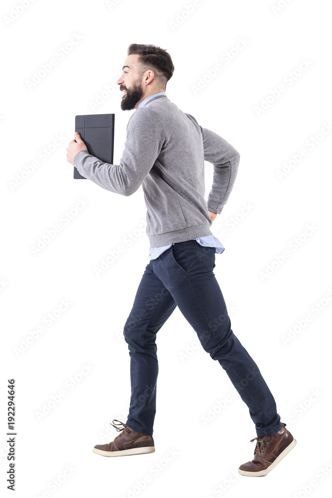Profile view of young businessman with notebook running. Deadline concept. Full body length portrait isolated on white studio background. Profile view of young businessman with notebook running. Deadline concept. Full body length portrait isolated on white studio background.